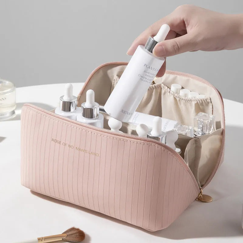 Vertical pattern pillow-shaped cubic makeup bag in PU material for women's travel storage.