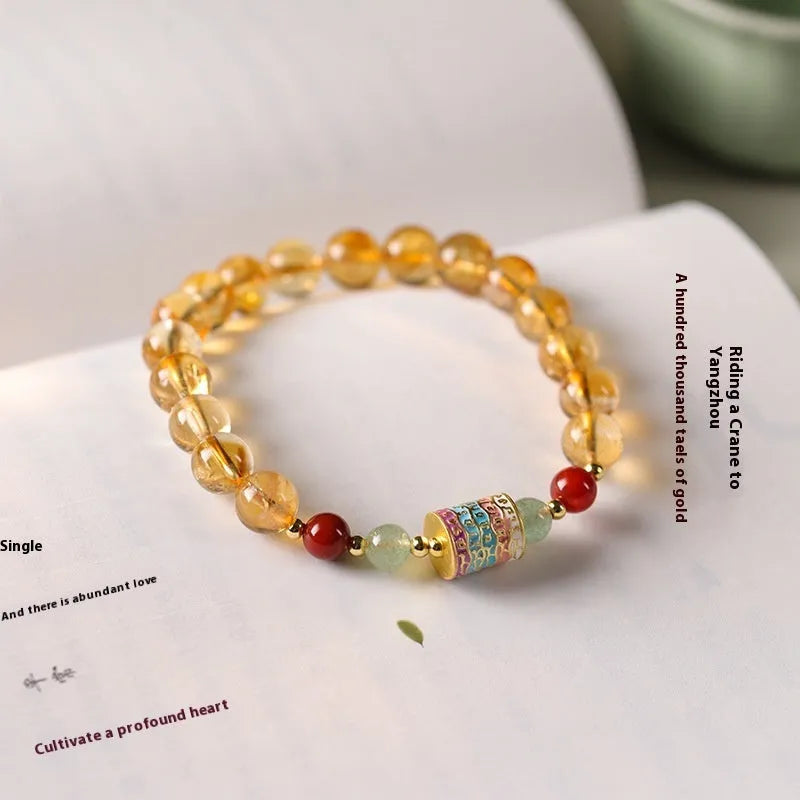 Yellow citrine bracelet with colourful prayer wheel beads on an 8mm round bead strand.