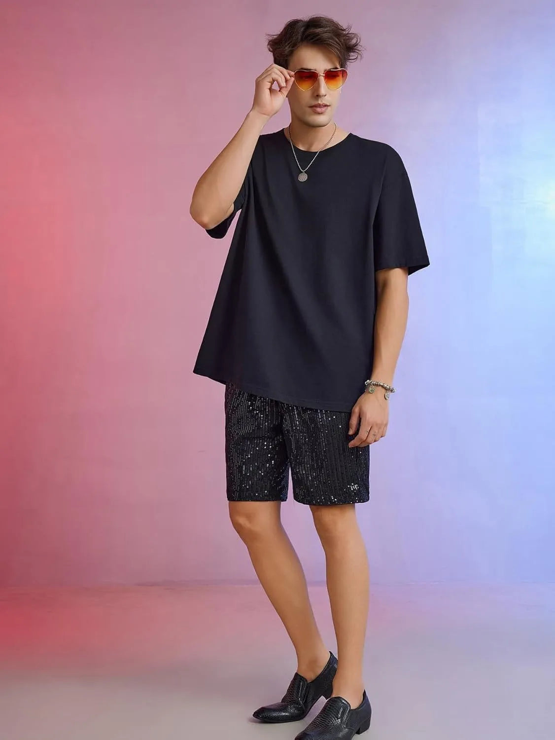 Men's straight-leg shorts with shiny sequins in silver or black, showing elastic waistband.