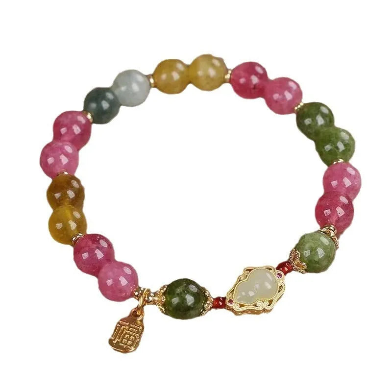 Close-up of a women's gourd blessing card bracelet with colourful tourmaline stones and electroplated finish.