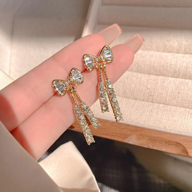 Gold alloy butterfly earrings with rhinestone accents and bow design for women