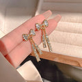 Gold alloy butterfly earrings with rhinestone accents and bow design for women