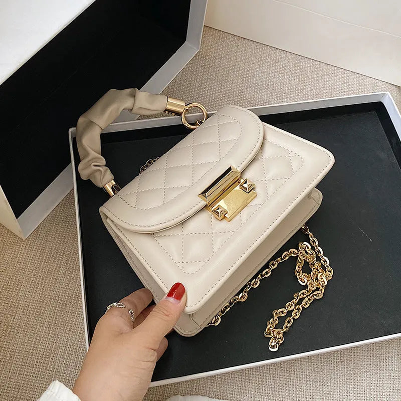 Purple Korean-style ladies square crossbody bag with soft PU texture on a table.