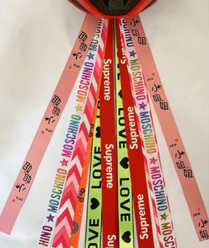 A decorative ribbon streamer for attaching to a child's roller skate or ski helmet, shown in a selection of colours.