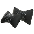 Black quilted leather car headrest pillow with contrast stitching, shown on a car seat.