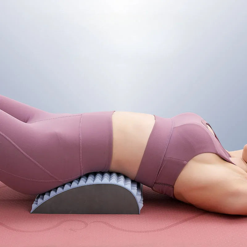 Blue back stretcher pillow for lumbar and neck support on a grey background.