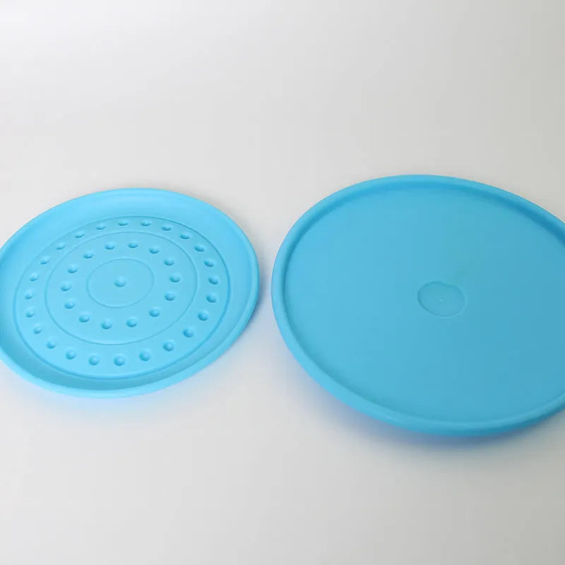 Plastic dog Frisbee disc in green colour, large size, for outdoor fetching and chewing.