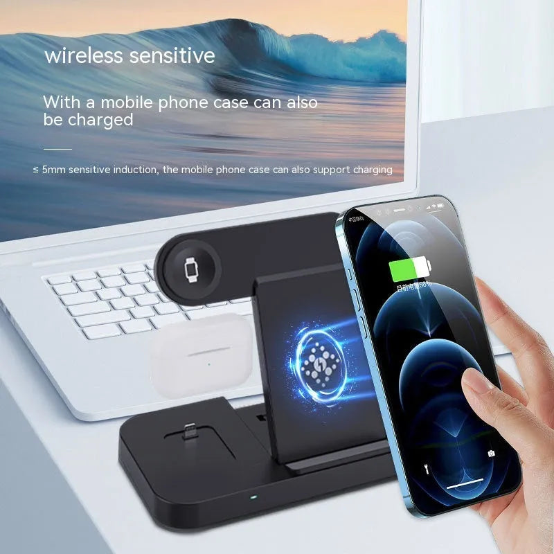 Black six-in-one foldable wireless charger with phone, earbuds, and watch charging zones on a desk