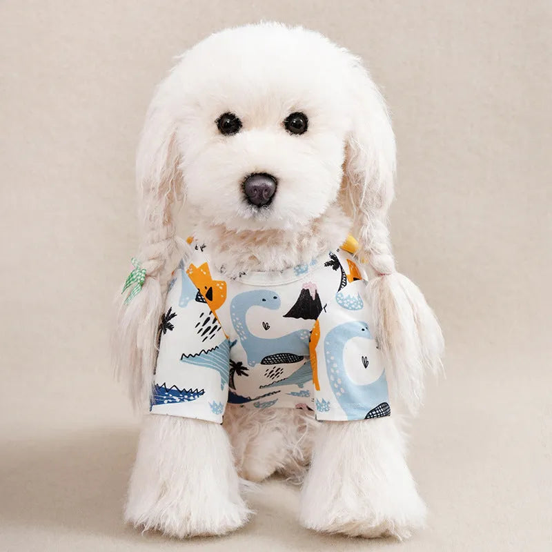 Casual printed polyester T-shirt for a small dog on a green background, showing the colourful design.