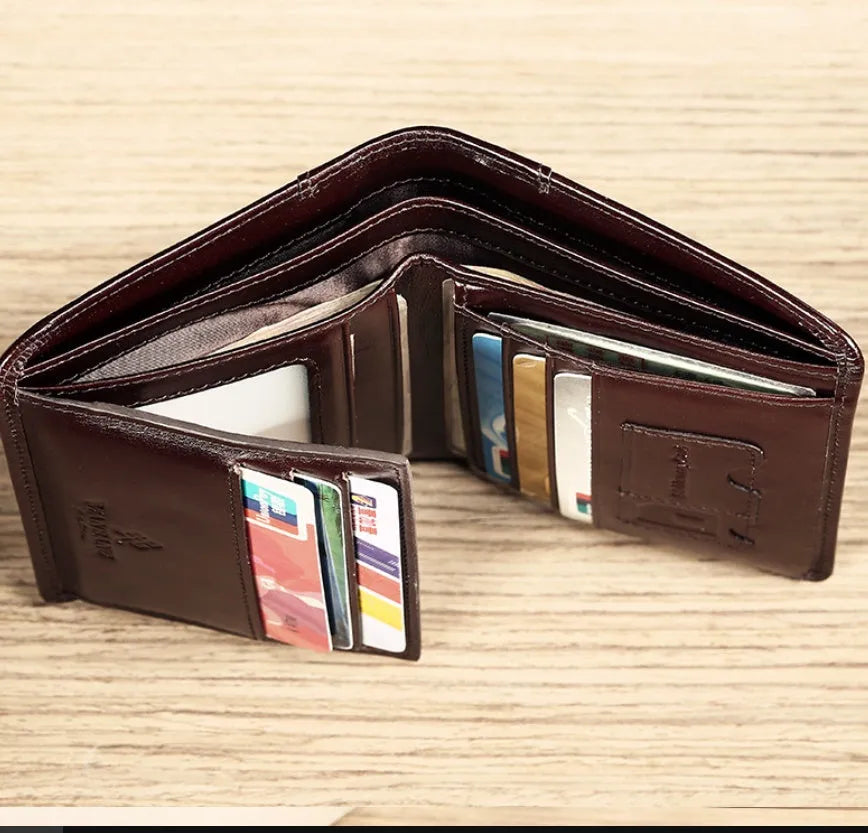 Men's black full-grain leather bifold wallet showing open interior with card slots and an exterior zippered coin pouch.
