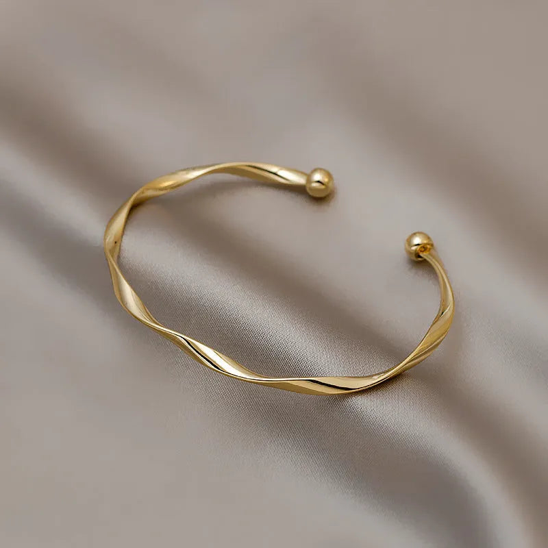 Gold twisted alloy bracelet with geometric Korean style design and 6.2cm inner ring diameter