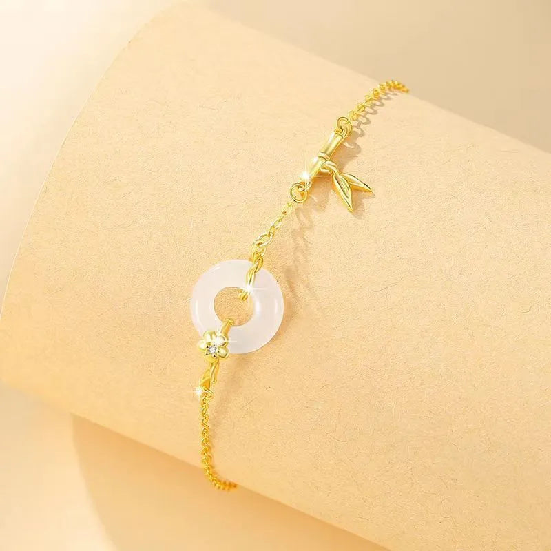 Silver bracelet with white chalcedony stone and starry sky patterned gold peace buckle.