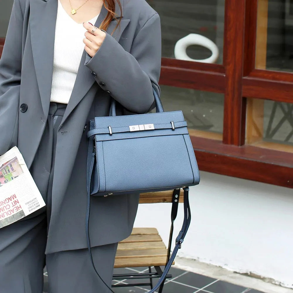 Small square horizontal genuine leather shoulder bag in almond green with visible stitching and shoulder strap