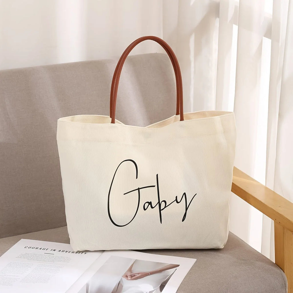Beige white canvas tote bag with long handles and a front view showing its structured shape