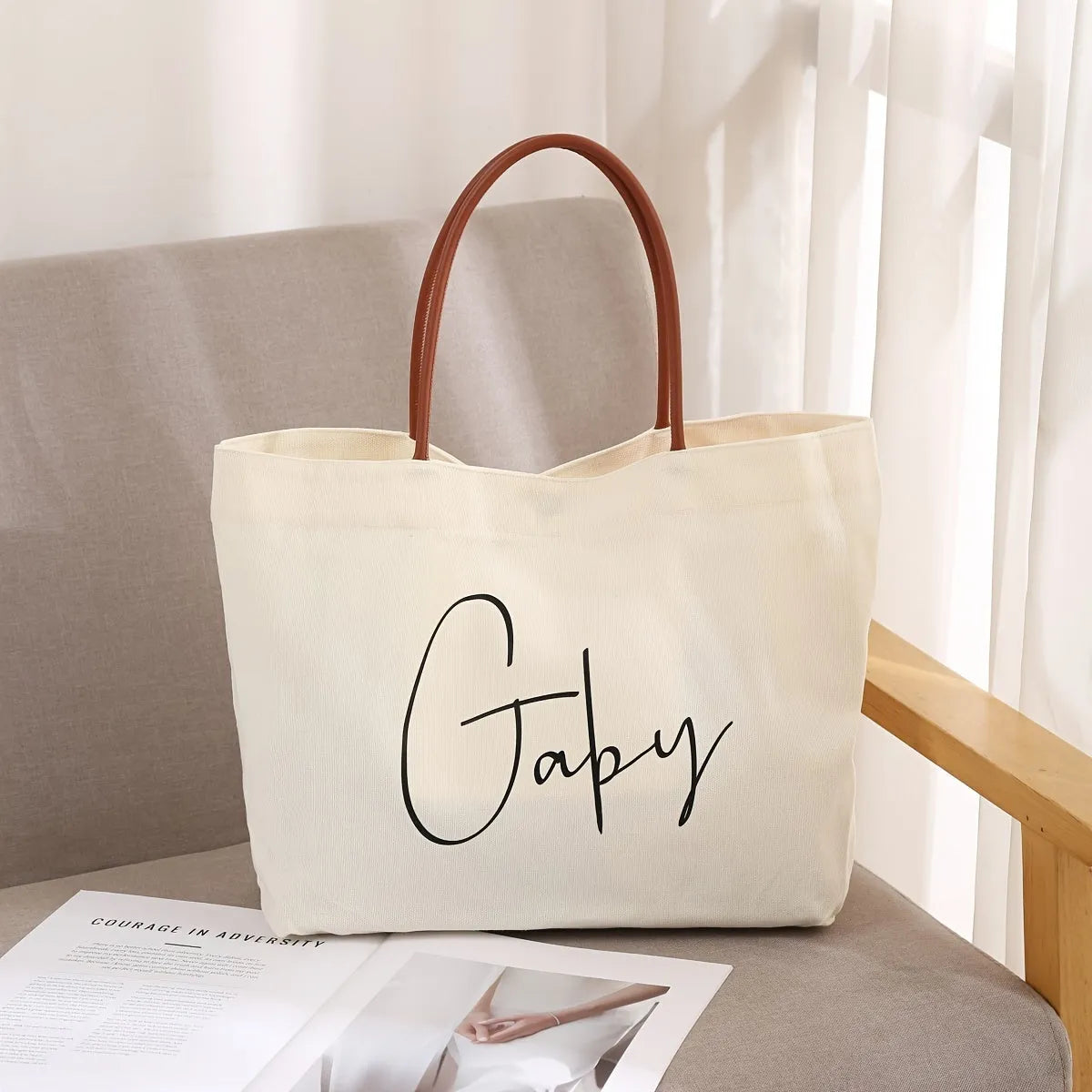 Beige white canvas tote bag with long handles and a front view showing its structured shape