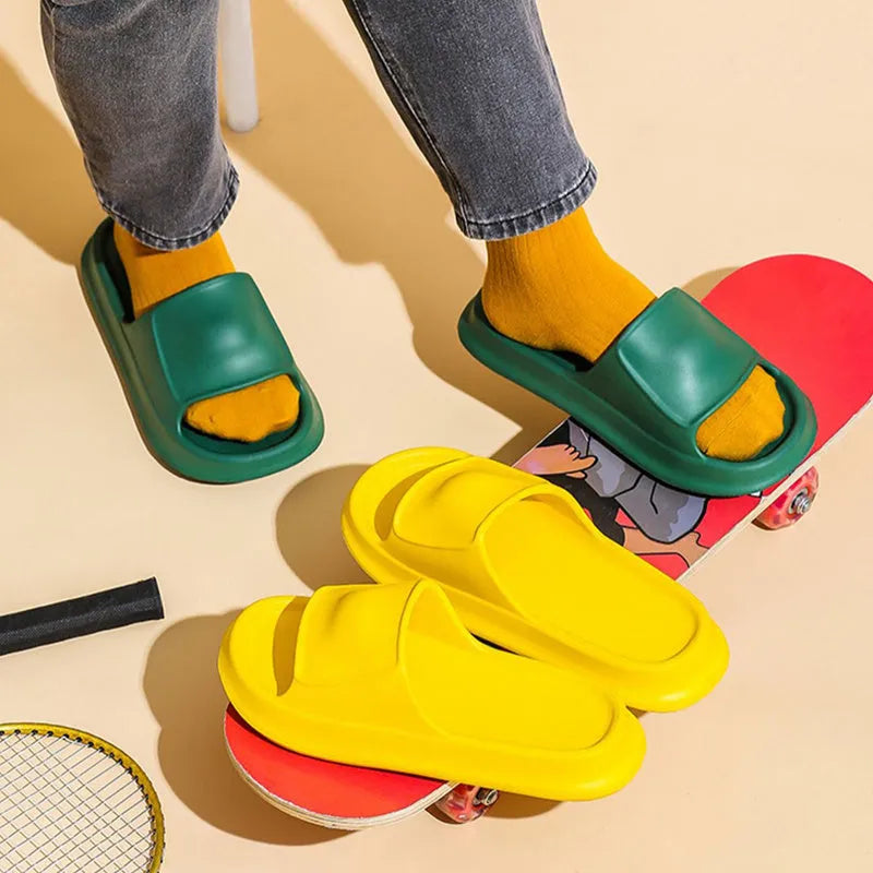Pair of white EVA flip-flop slippers with a thick, textured sole on a tiled floor.