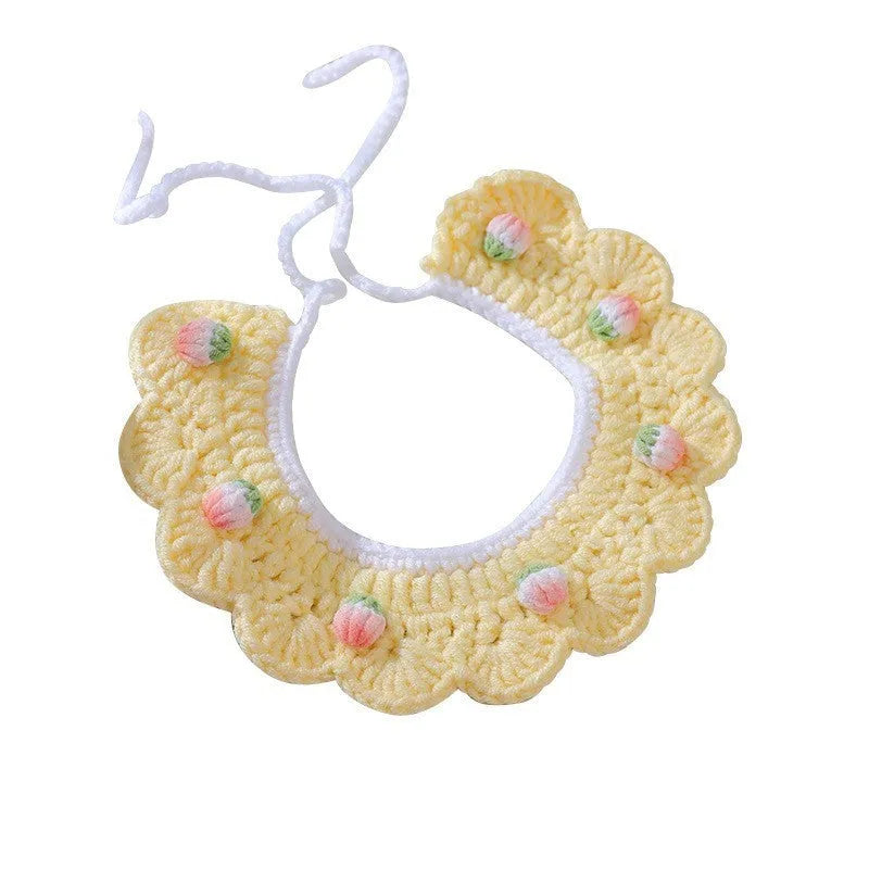 Handmade woven wool cat collar with embroidered cartoon British Shorthair kitten in pink, white, and yellow colours.
