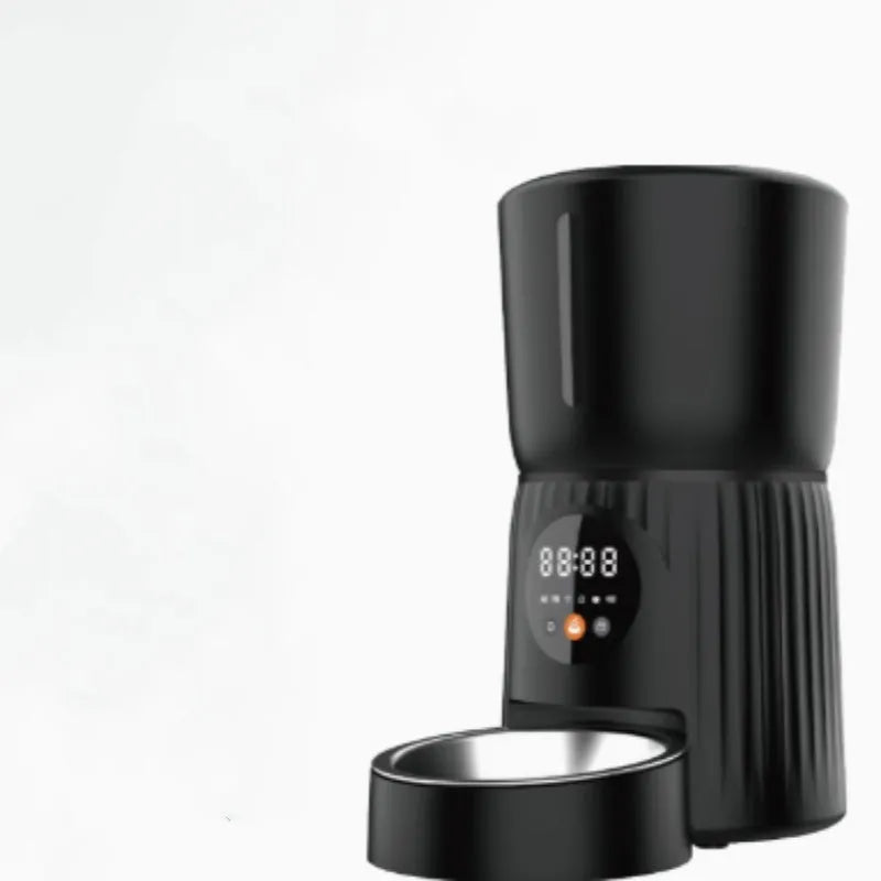 Black and white automatic pet feeder with digital display, food hopper, and USB cable.