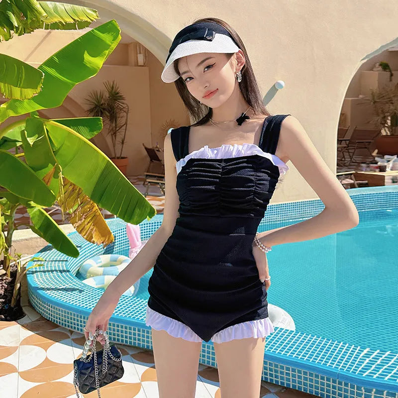 Women's one-piece swimsuit with suspender straps in solid colour options