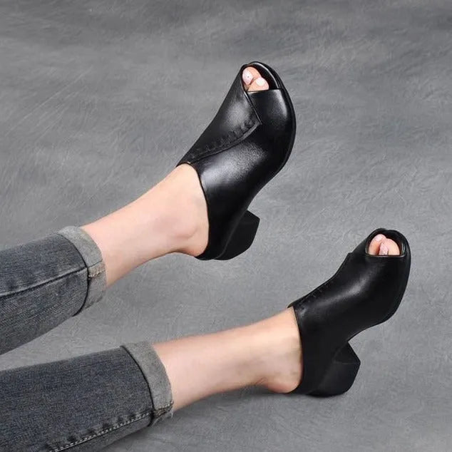 Women's black square heel peep-toe slippers with a fish-mouth scaffold design on a white background.
