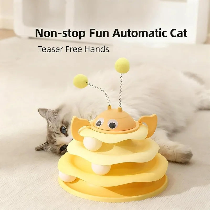 Cat toy tower with rotating bee toy and three-layer trackball in green plastic, placed on a wooden floor