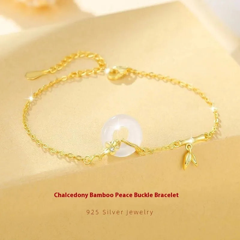 Silver bracelet with white chalcedony stone and starry sky patterned gold peace buckle.
