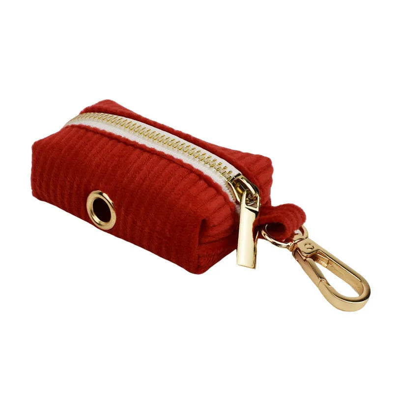 Red corduroy dog collar and leash set with matching vest, bow tie, and poo bag