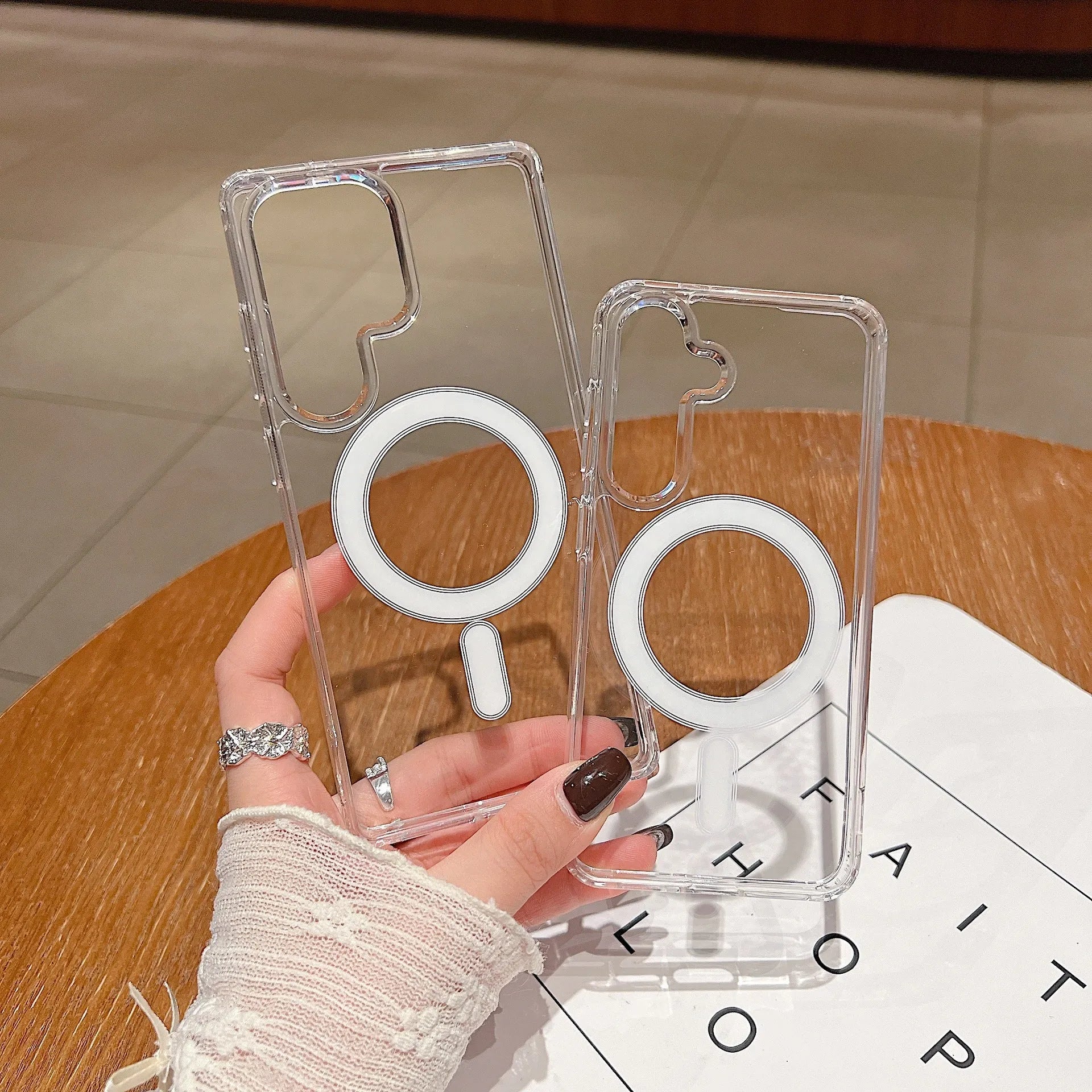 Transparent magnetic silicone phone case for Samsung Galaxy and A-series smartphones on a flat surface.