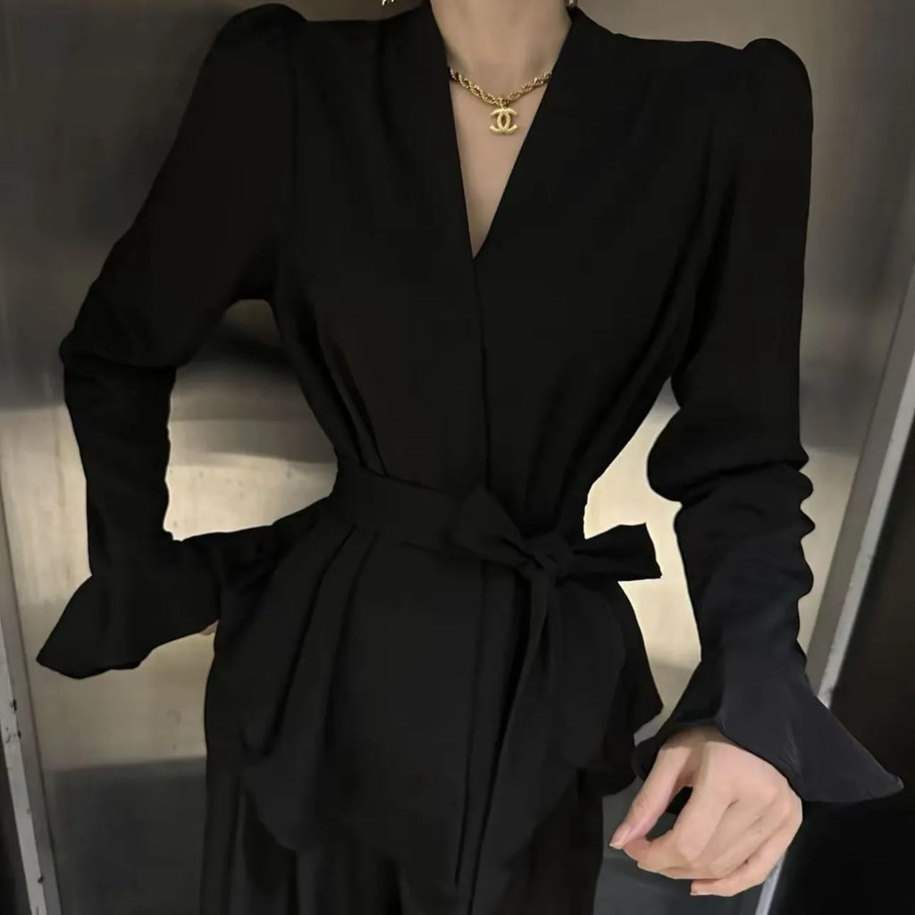 Women's black French-style long sleeve shirt with irregular collar, bell sleeves, and a tied front.