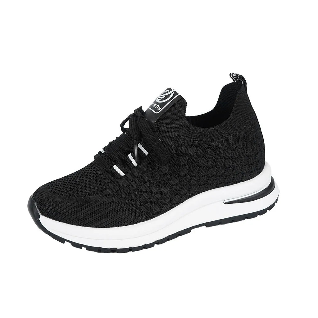 Women's black platform sneakers with mesh upper and lace-up front on flat rubber sole
