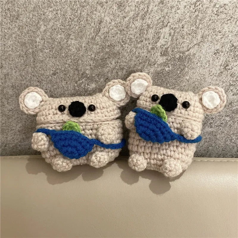 Hand-knitted grey koala bear design cover on a white Airpods case.