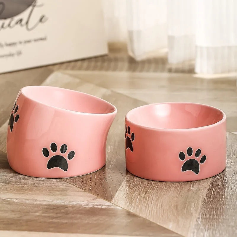 Ceramic cat bowl with cat paw design in black, showing oblique mouth style.