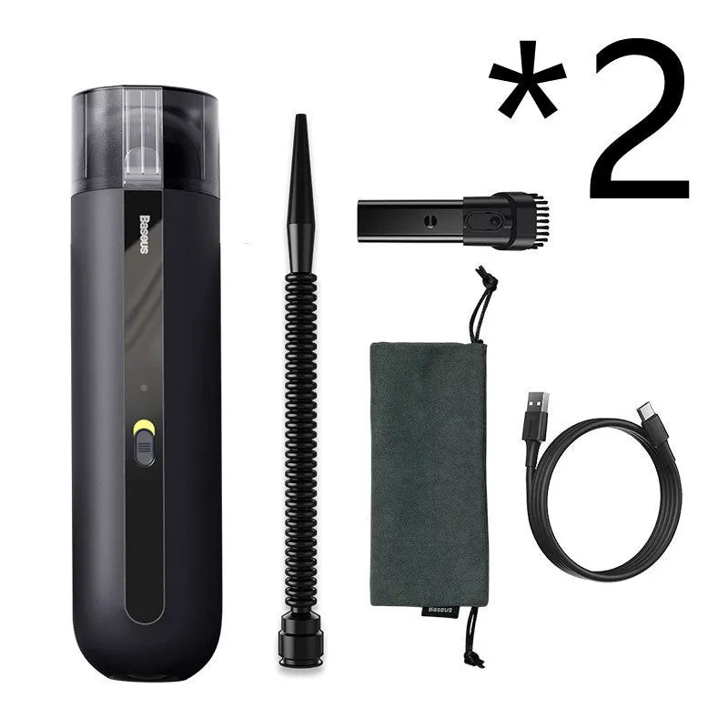 Starry sky black handheld cordless car vacuum cleaner with blowing hose accessory on a desktop.