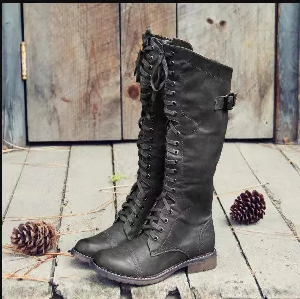 Women's black chunky heel high leg boots with a round toe and pull-on design.