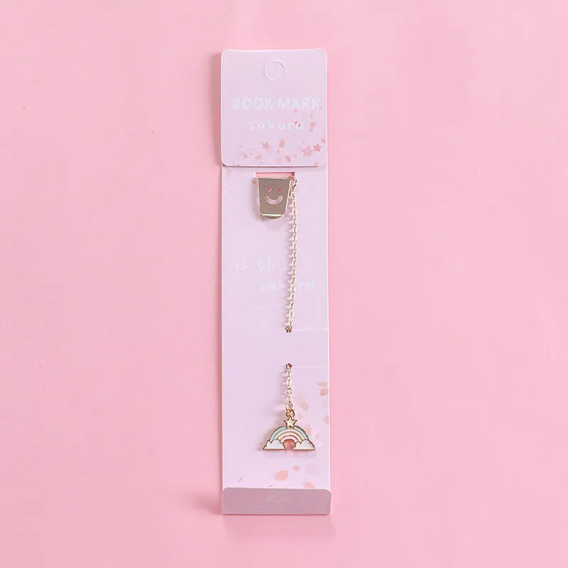 Cartoon-themed alloy metal bookmark charm on a book page.