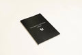 Black hardcover dream journal notebook with lined pages open.