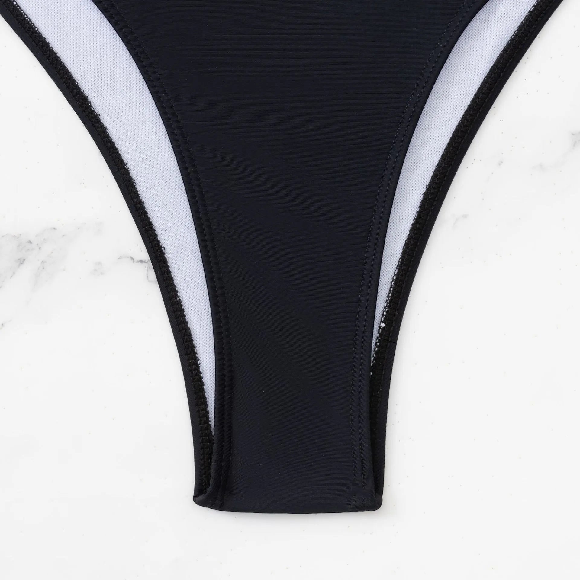 Black women's one-piece swimsuit with white contrast stitching and hollow design detail
