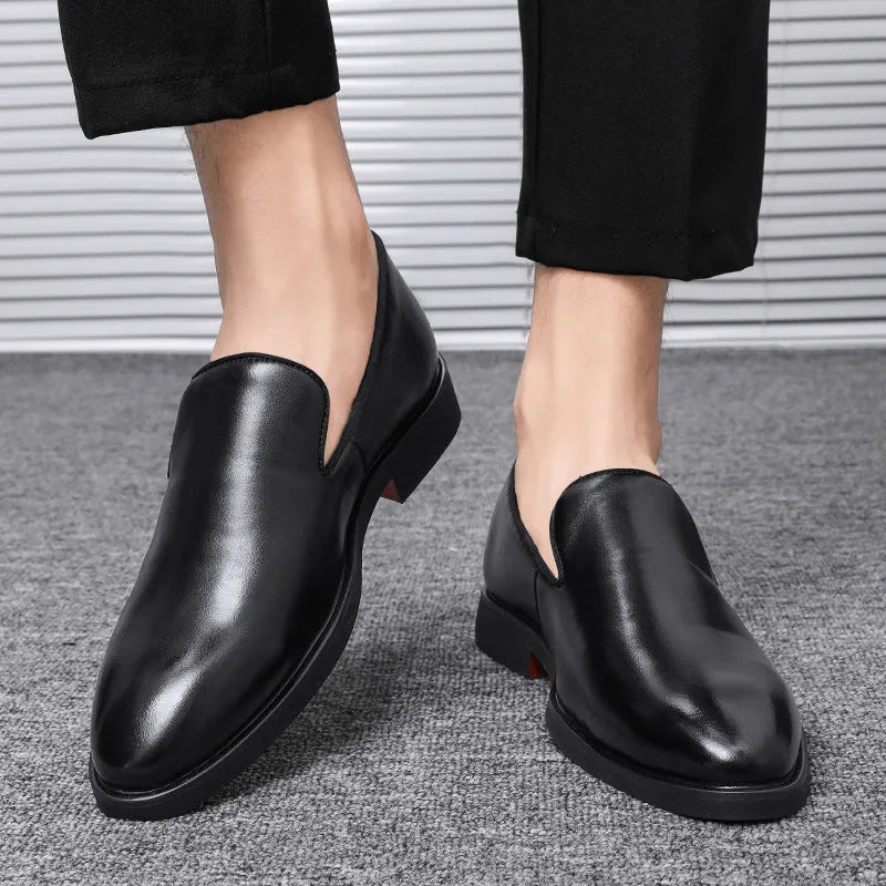 Men's polished pointed black leather shoes with leather toe cap and rubber sole, side view