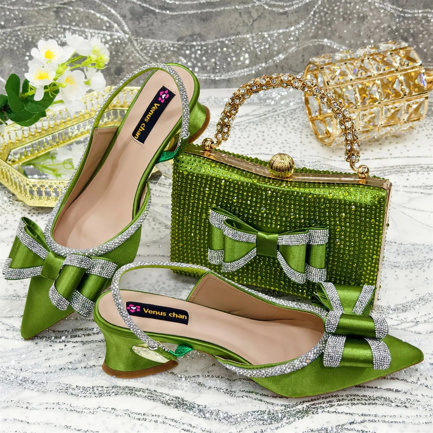 Women's black pointed toe sandals with square buckle and matching rhinestone bag on a mid-height wine glass heel.