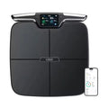 Black square eight-electrode body fat scale on a bathroom floor