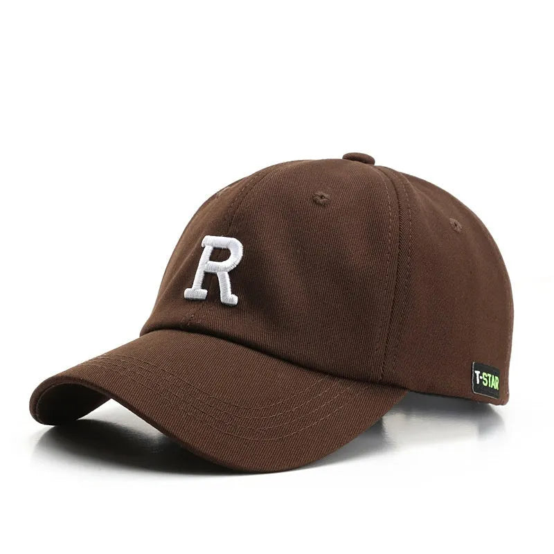 Adjustable cotton baseball cap with embroidered letter R in beige colour, dome style, unisex design
