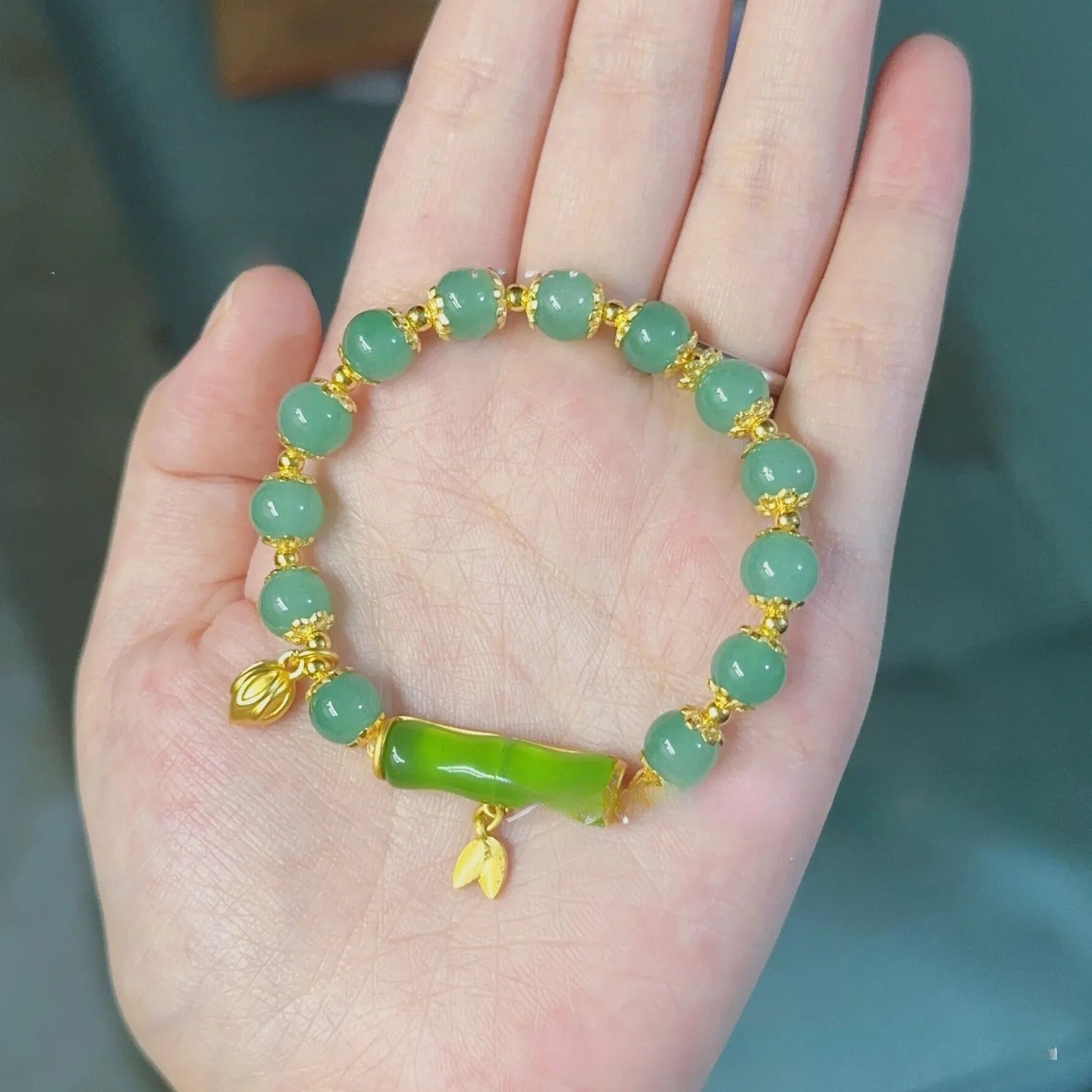 Bamboo-themed glass bracelet with coloured glaze beads and electroplated flower charm