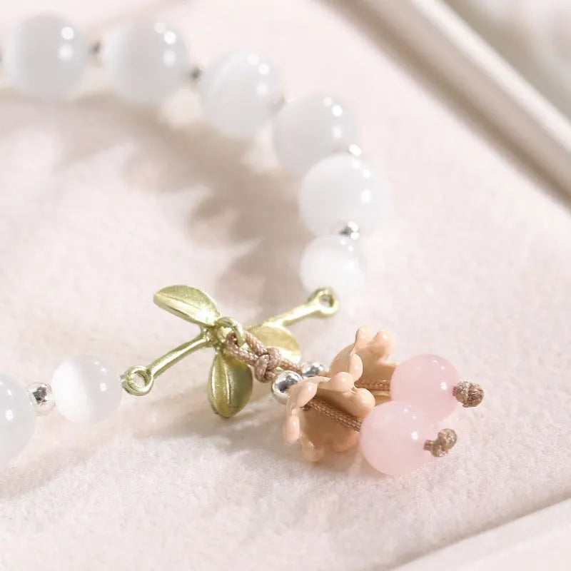 Close-up of electroplated opal cat's eye beaded bracelet for women with diamond-shaped charm