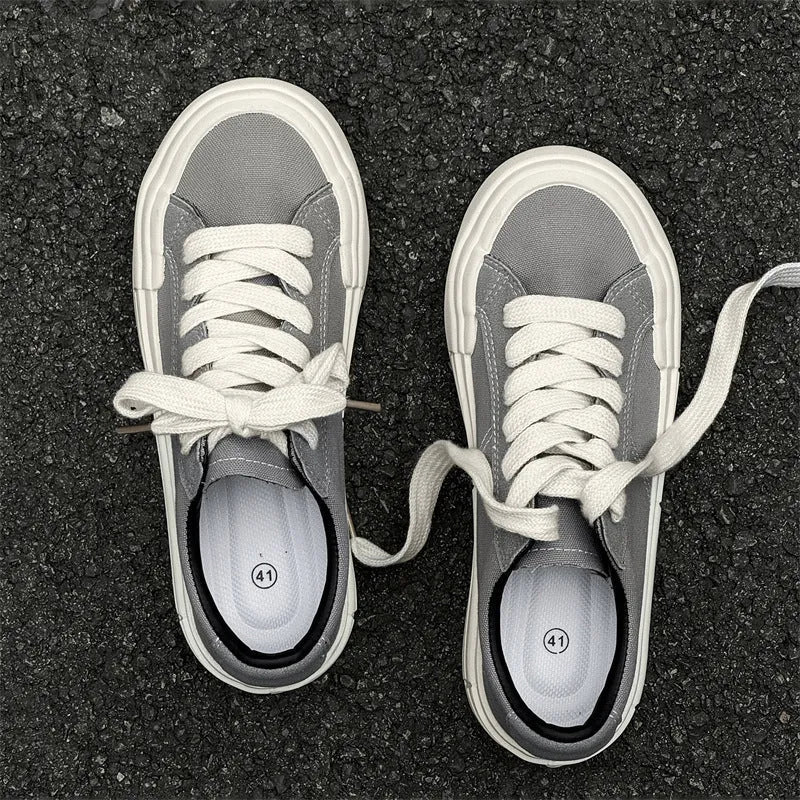 Canvas platform casual skate shoes with lace-up, tassel detail, and rubber sole in black and gray
