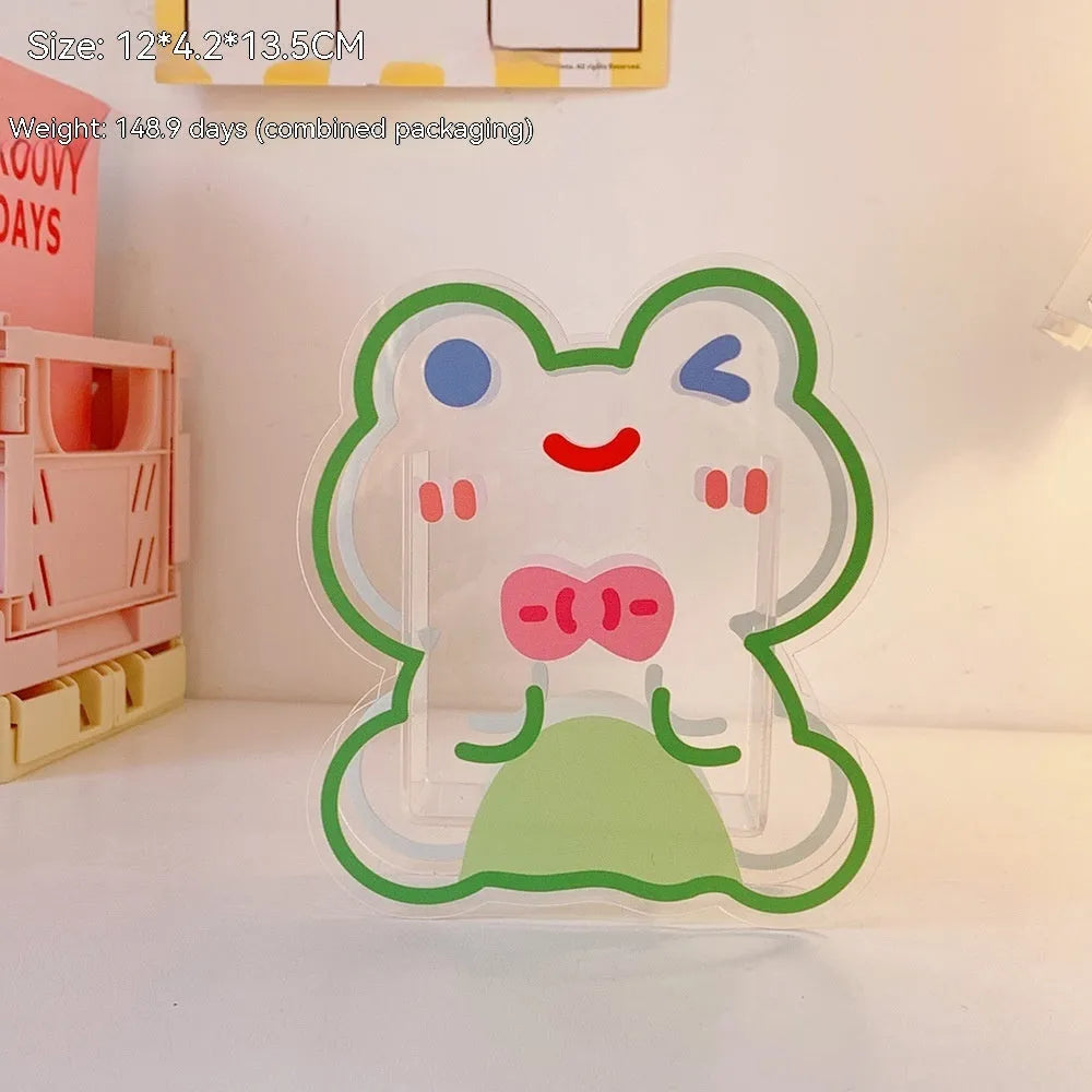 Clear square acrylic storage box with a colourful printed lid featuring a cute design, shown holding pens and stationery.