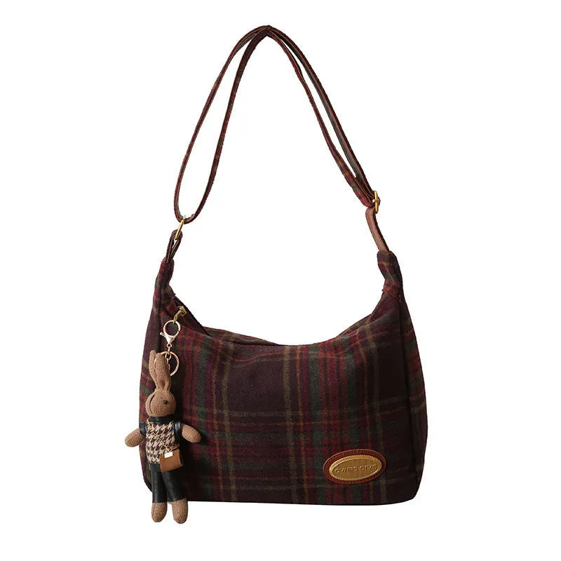 Women's woolen shoulder bag in horizontal square shape with cross-body strap and decorative sewing lines