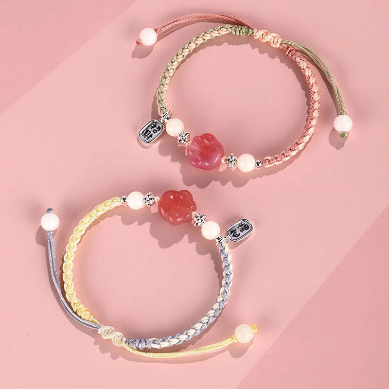 Red cat's paw charm couples bracelet with pink woven base, handmade glass and glaze jewellery