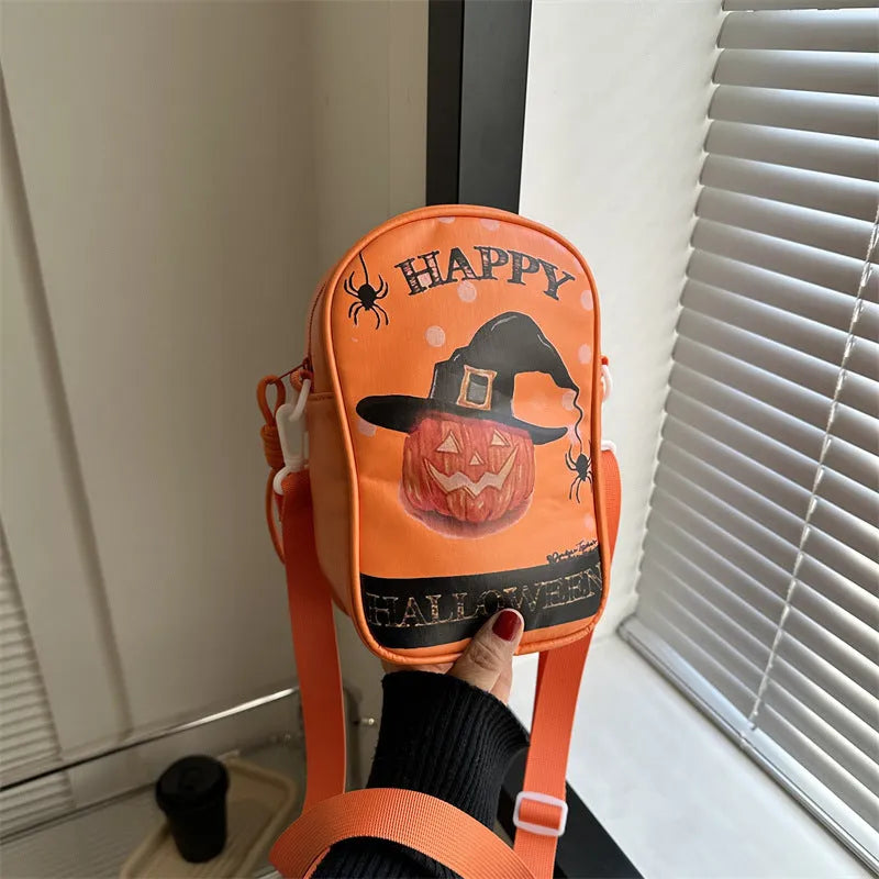 Black Halloween graffiti crossbody bag with cartoon pumpkin, ghost, and bat print, shown with adjustable strap.
