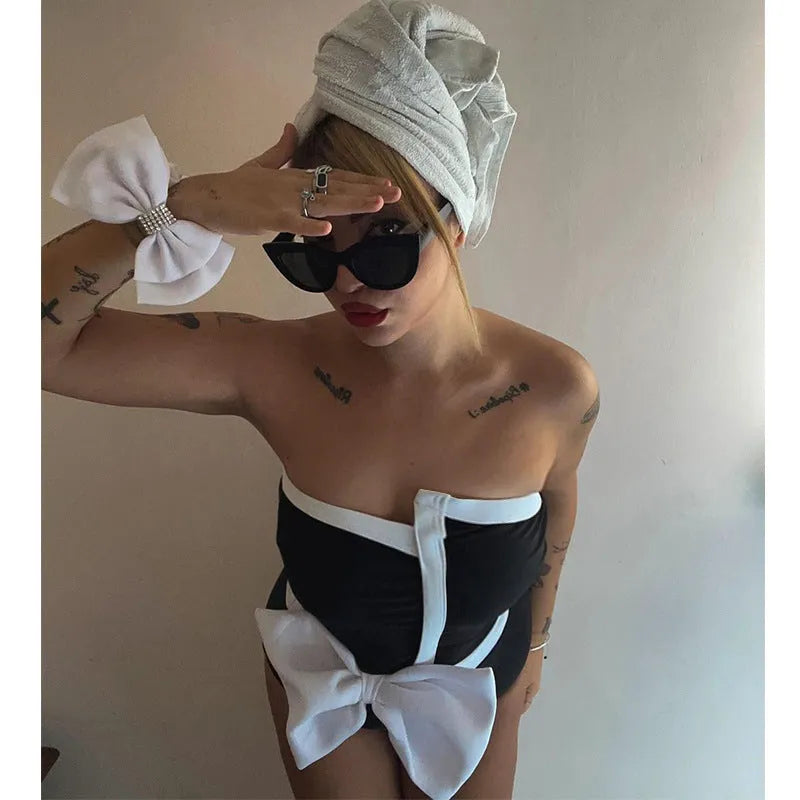 Black and white colour-block women's one-piece swimsuit with an asymmetrical bow on the tube top.