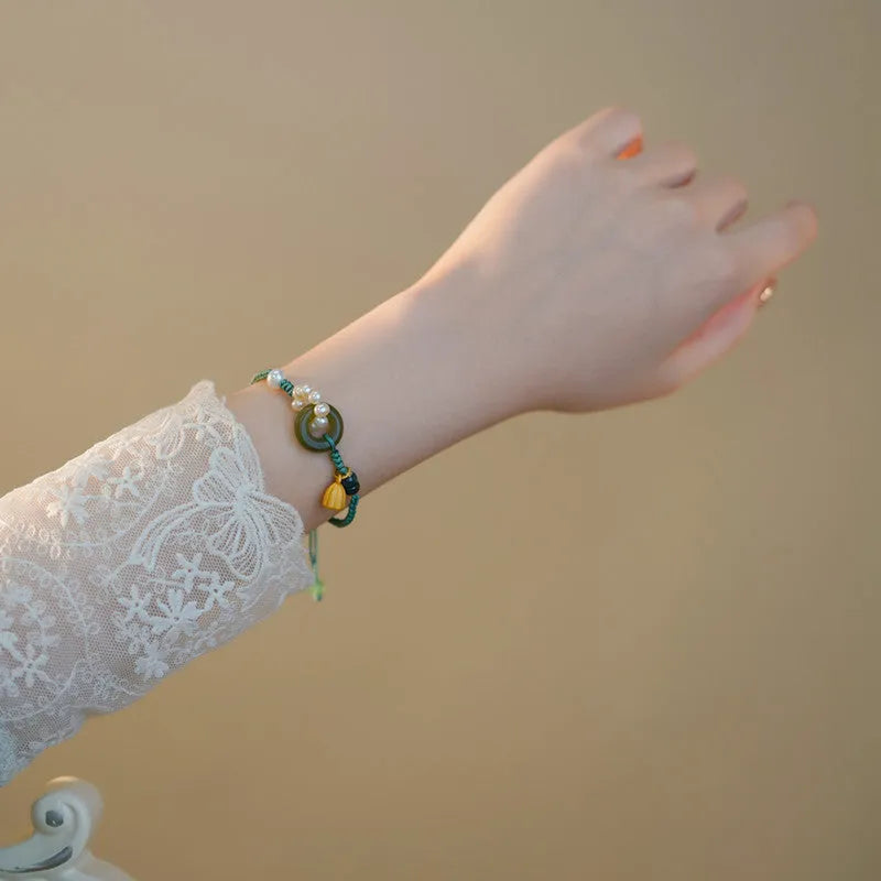 Hand-woven flexible wire watch bracelet with a pearl peace buckle in retro style for women.